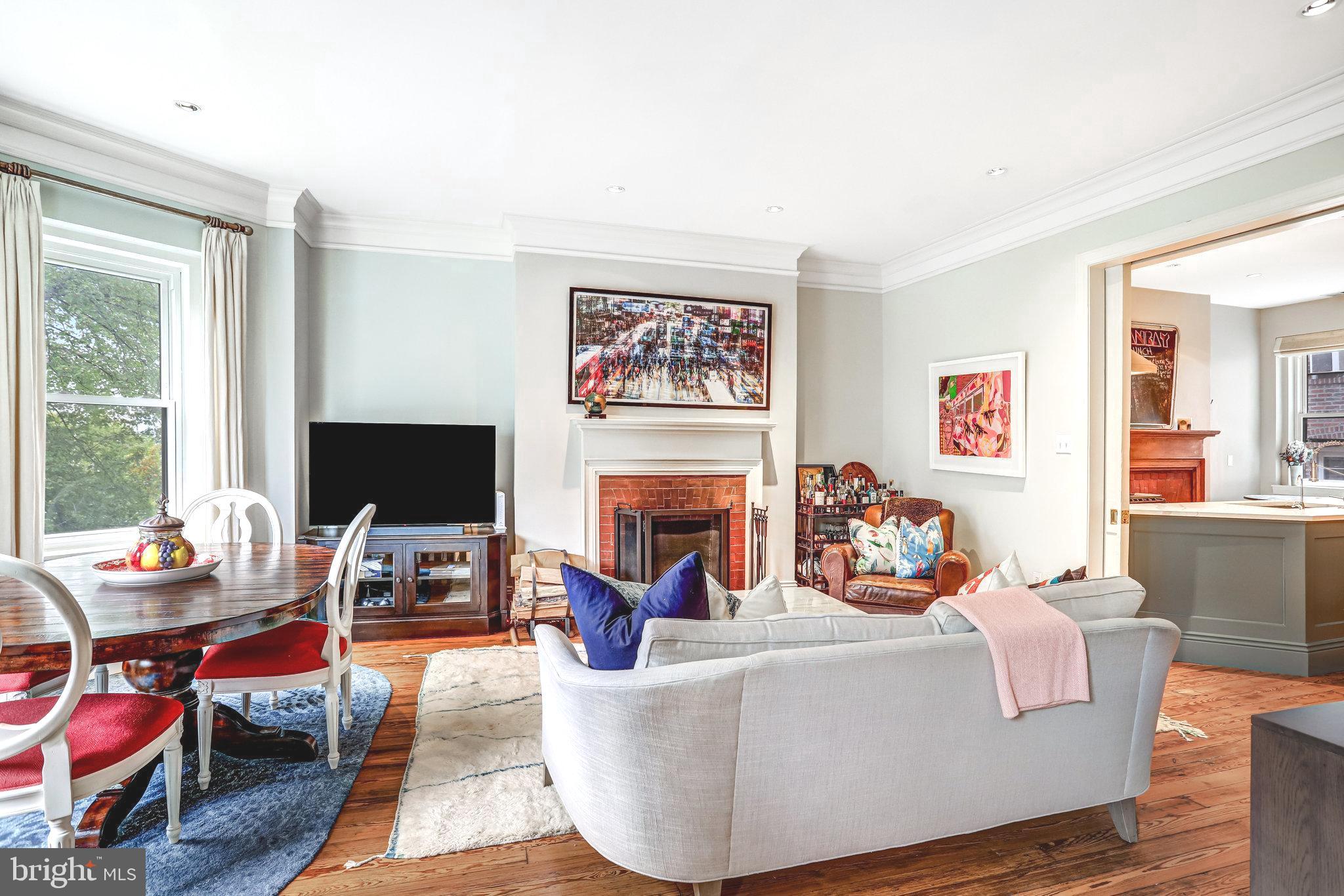1820 Kalorama Road Northwest, Unit 3 Washington, DC 20009 - Photo 7 of 32 a living room with furniture a fireplace and a flat screen tv