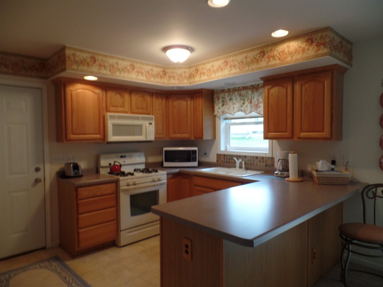 419 Elizabeth Road Oregon, IL 61061 - Photo 7 of 13 a kitchen that has a sink cabinets counter space and appliances