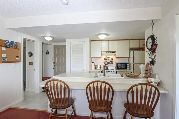 a dining room with furniture a window and wooden floor