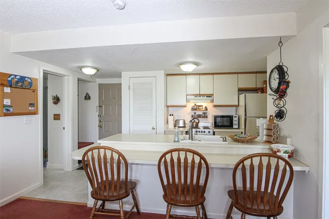a dining room with furniture a window and wooden floor