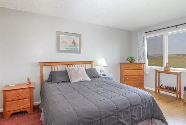 a bedroom with a bed and a table