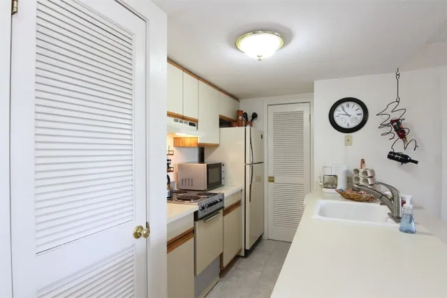 a view of a kitchen with a car parked in it