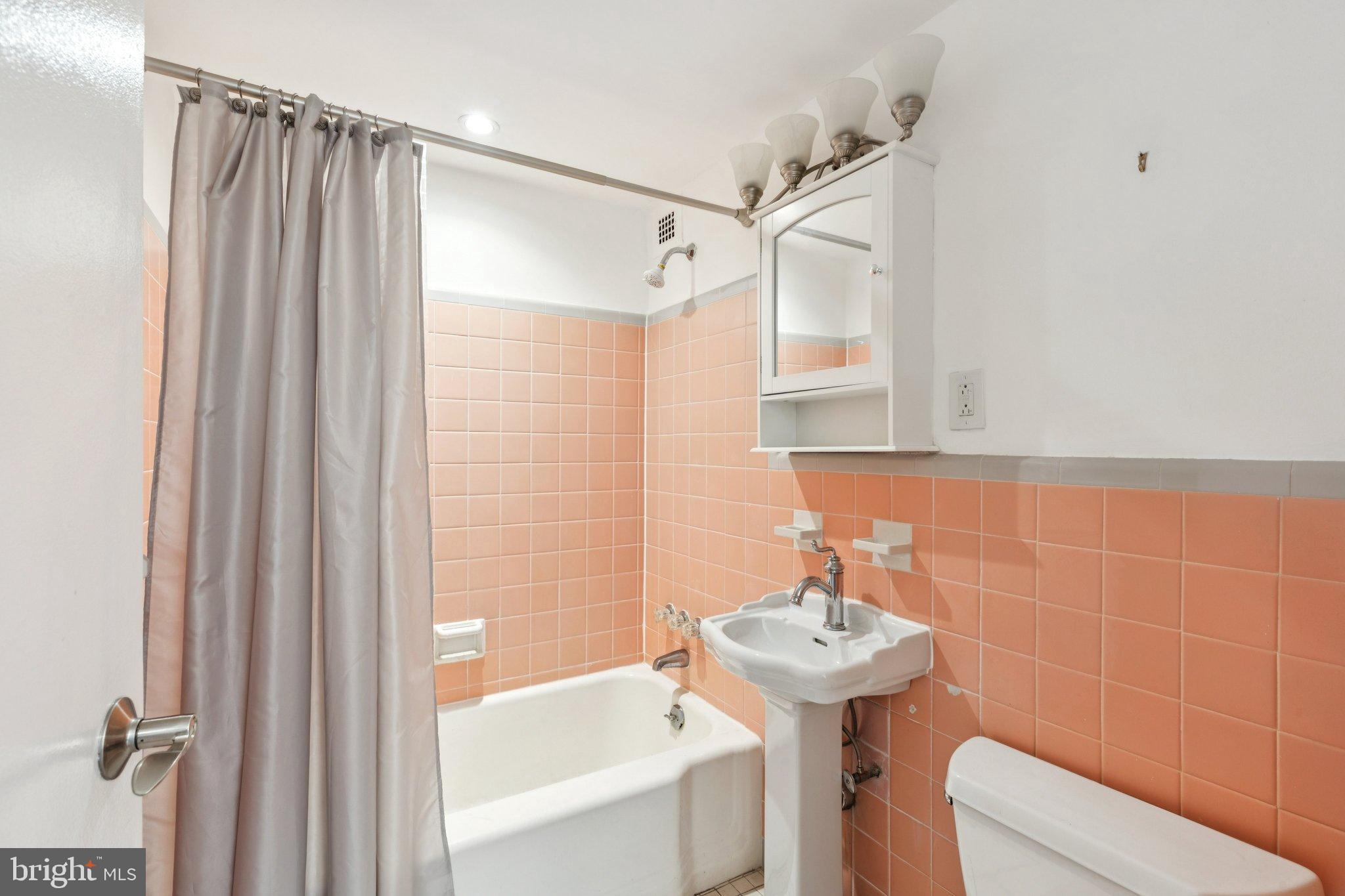 1810 Rittenhouse Square, Unit 406 Philadelphia, PA 19103 - Photo 11 of 17 Charming bathroom with retro pink tiles.