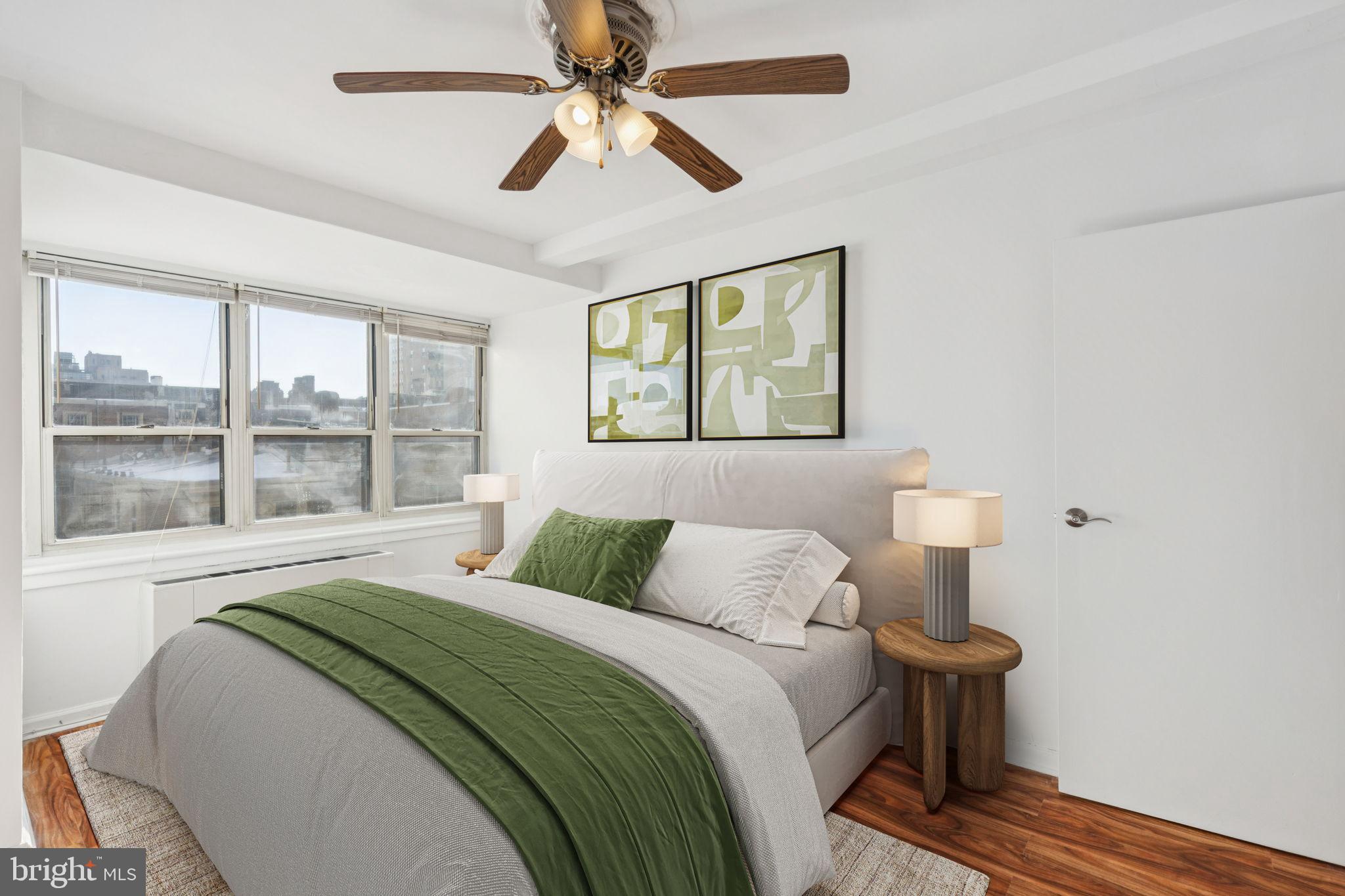 1810 Rittenhouse Square, Unit 406 Philadelphia, PA 19103 - Photo 14 of 17 Serene bedroom with city skyline views.