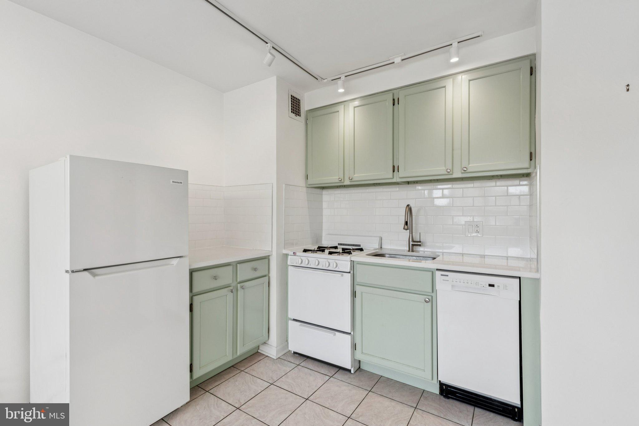 1810 Rittenhouse Square, Unit 406 Philadelphia, PA 19103 - Photo 9 of 17 Charming kitchen with mint green cabinetry.