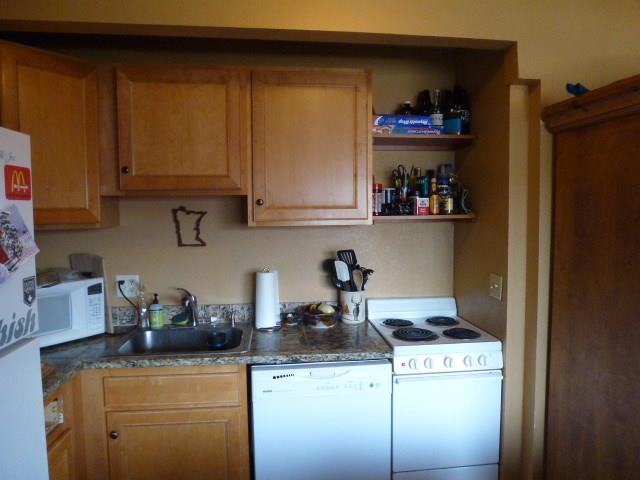 150 Evergreen Road, Unit 205 Dillon, CO 80435 - Photo 4 of 18 a kitchen with a cabinets and a stove top oven