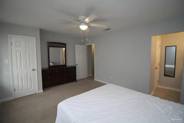 a bedroom with a bed and a dresser