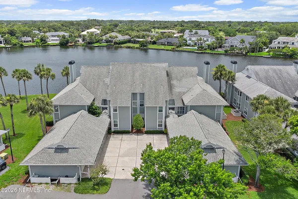 an aerial view of a house with a lake view
