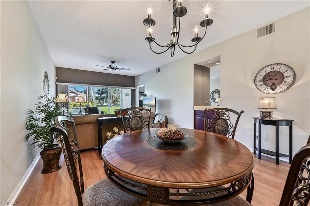 565 Augusta Boulevard, Unit 24 Naples, FL 34113 - Photo 13 of 26 a view of a dining room with furniture window and wooden floor