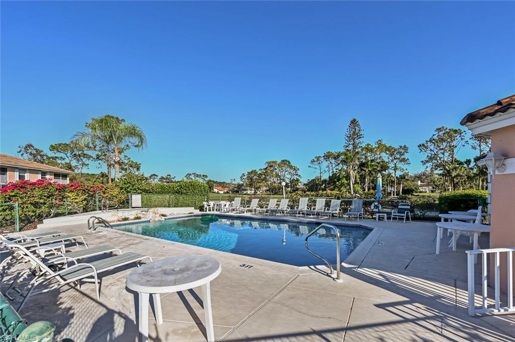 565 Augusta Boulevard, Unit 24 Naples, FL 34113 - Photo 14 of 26 a view of a chairs and table on the terrace