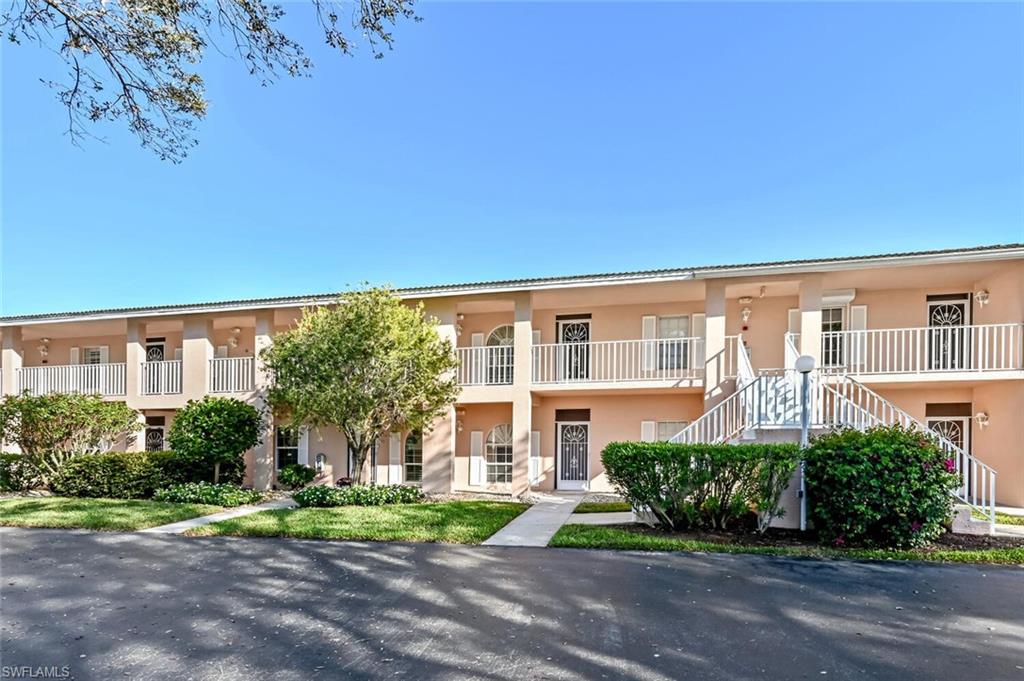 565 Augusta Boulevard, Unit 24 Naples, FL 34113 - Photo 15 of 26 a front view of a house with a yard