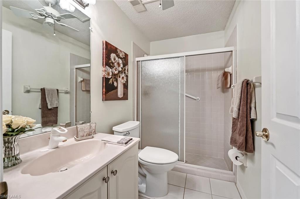 565 Augusta Boulevard, Unit 24 Naples, FL 34113 - Photo 18 of 26 a bathroom with a sink toilet and shower