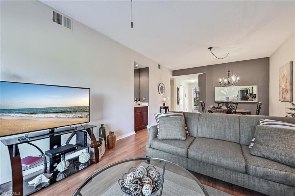 565 Augusta Boulevard, Unit 24 Naples, FL 34113 - Photo 20 of 26 a living room with furniture and wooden floor