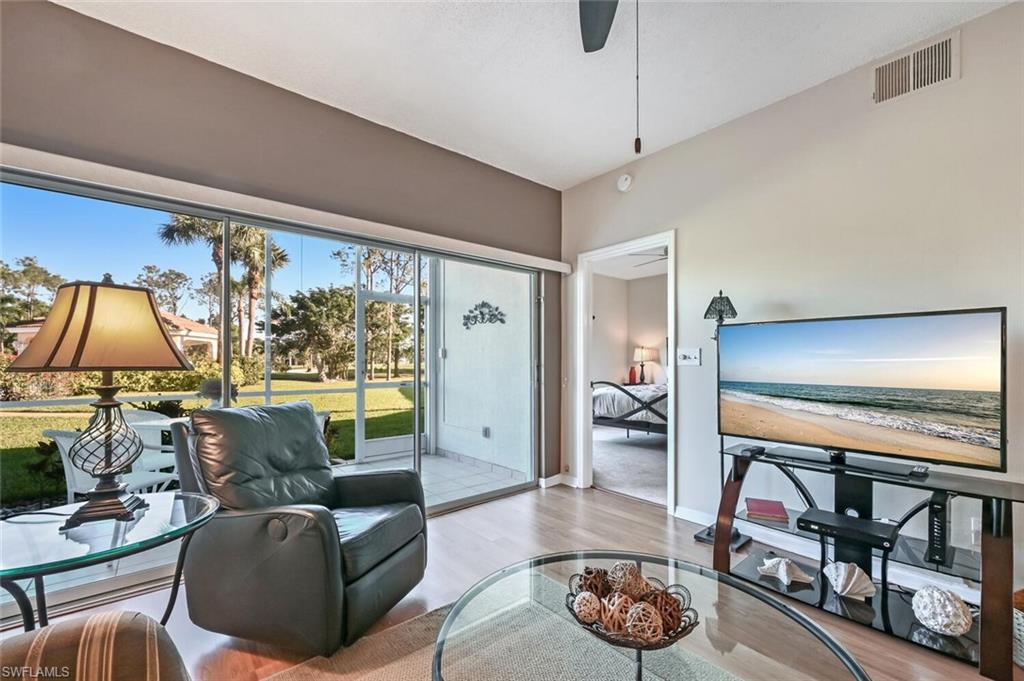 565 Augusta Boulevard, Unit 24 Naples, FL 34113 - Photo 3 of 26 a living room with furniture and a flat screen tv