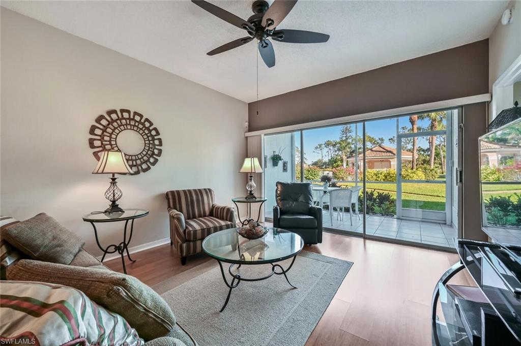 565 Augusta Boulevard, Unit 24 Naples, FL 34113 - Photo 5 of 26 a living room with furniture and a large window