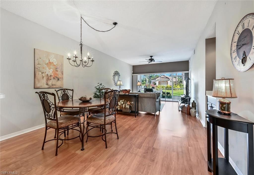 565 Augusta Boulevard, Unit 24 Naples, FL 34113 - Photo 7 of 26 a view of a dining room with furniture window and wooden floor