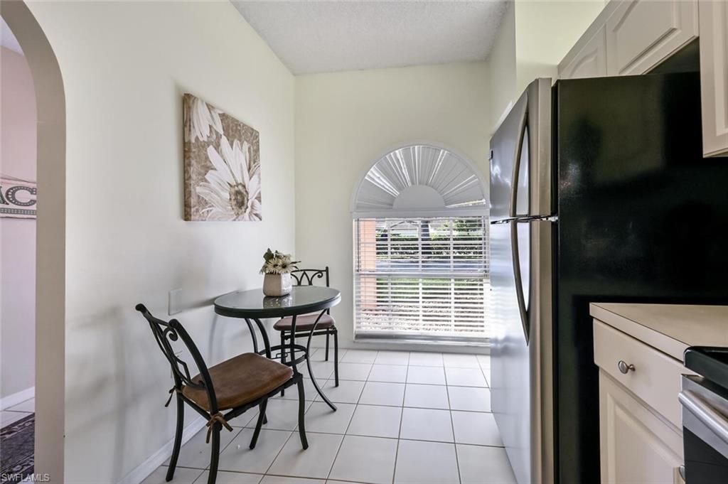 565 Augusta Boulevard, Unit 24 Naples, FL 34113 - Photo 9 of 26 a view of a dining room with furniture window and outside view