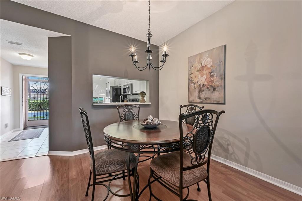 565 Augusta Boulevard, Unit 24 Naples, FL 34113 - Photo 10 of 26 a dining room with furniture and window