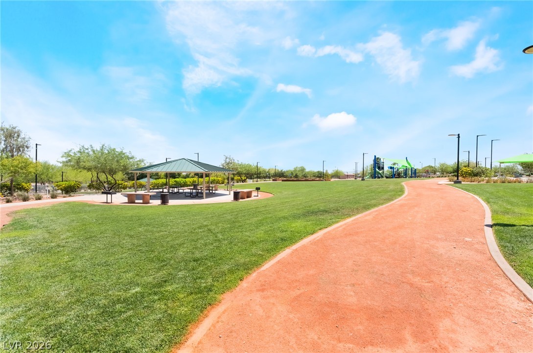 6432 Spring Jog Street Las Vegas, NV 89166 - Photo 42 of 61 A winding path leads through green fields to a shaded picnic area and playground.