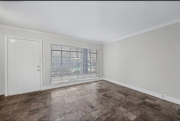a view of an empty room with glass door