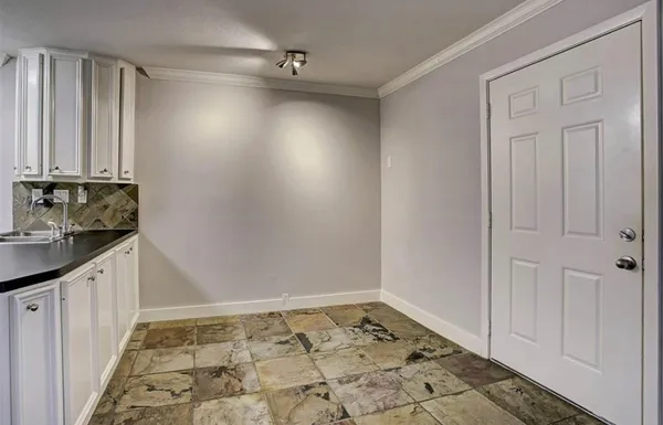 a view of an empty room and staircase