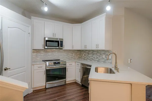 a kitchen with a stove and a microwave