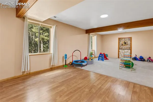 a view of a room with gym equipment and a window