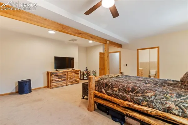 a bedroom with furniture and a flat screen tv