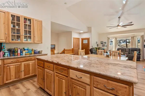 a kitchen with sink and view of living room