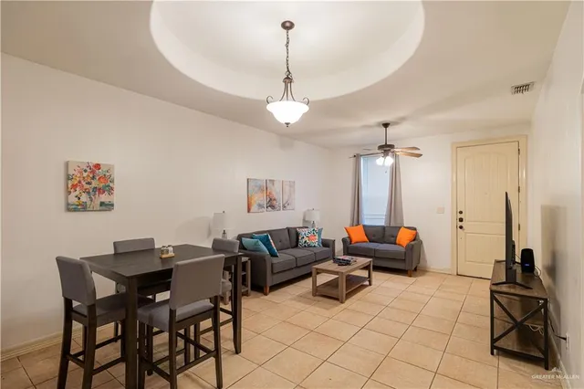 a living room with furniture a table and chairs