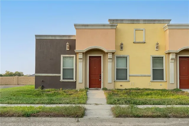 a view of a brick house with a large windows