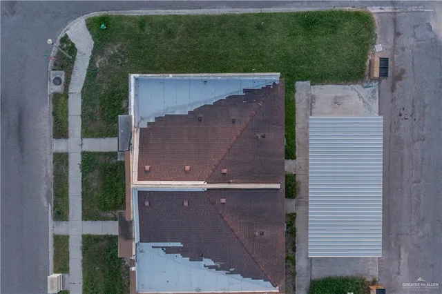 an aerial view of a house with a yard