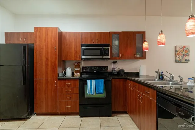 a kitchen with stainless steel appliances a refrigerator and a stove top oven