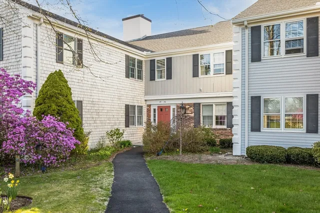 a front view of a house with garden