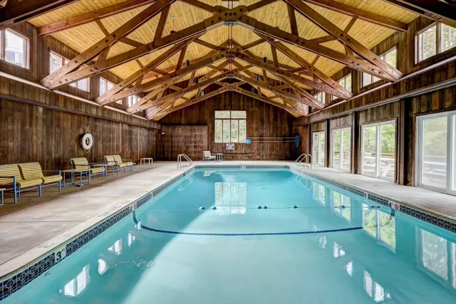 a view of a house with swimming pool and sitting area