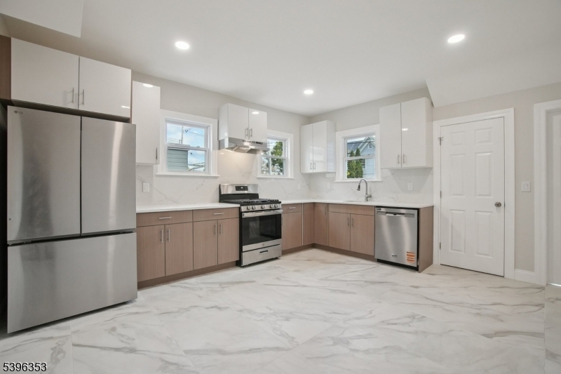 19 Ashwood Avenue, Unit 1 Summit, NJ 07901 - Photo 1 of 17 a large kitchen with a refrigerator sink and cabinets