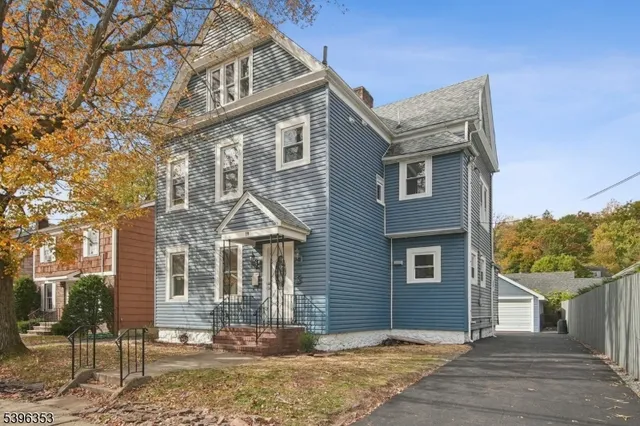front view of a house with a tree