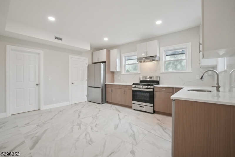 19 Ashwood Avenue, Unit 1 Summit, NJ 07901 - Photo 4 of 17 a kitchen with granite countertop a sink and stainless steel appliances