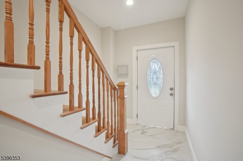 19 Ashwood Avenue, Unit 1 Summit, NJ 07901 - Photo 6 of 17 a view of staircase with railing and white walls