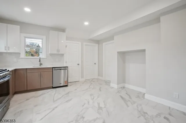 a view of a kitchen with a sink cabinets and wooden floor