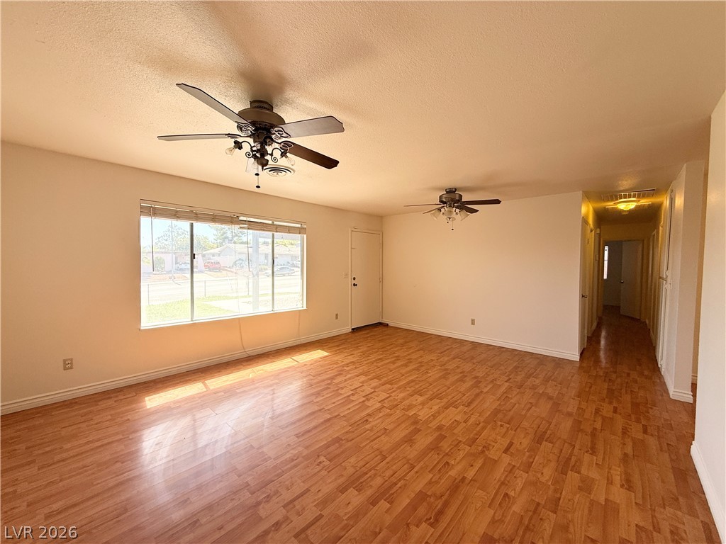 616 Greenway Road Henderson, NV 89002 - Photo 4 of 32 Natural light streams into this generously proportioned living area, featuring rich hardwood flooring.