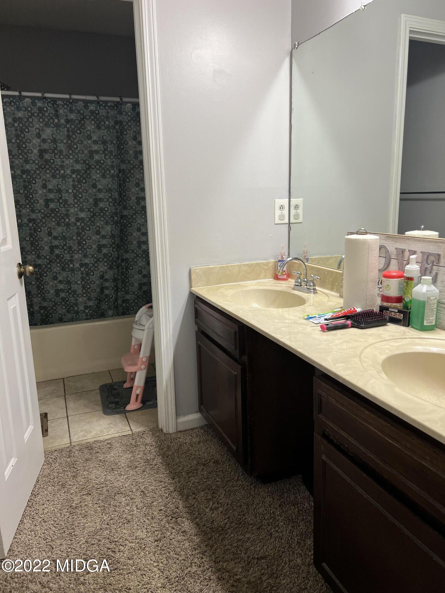 3821 Bobby Court Macon, GA 31216 - Photo 6 of 15 a bathroom with a sink a toilet and a mirror