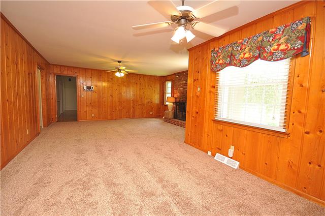 210 Bethlehem Road Lebanon, TN 37087 - Photo 8 of 16 en empty room with a window and a chandelier