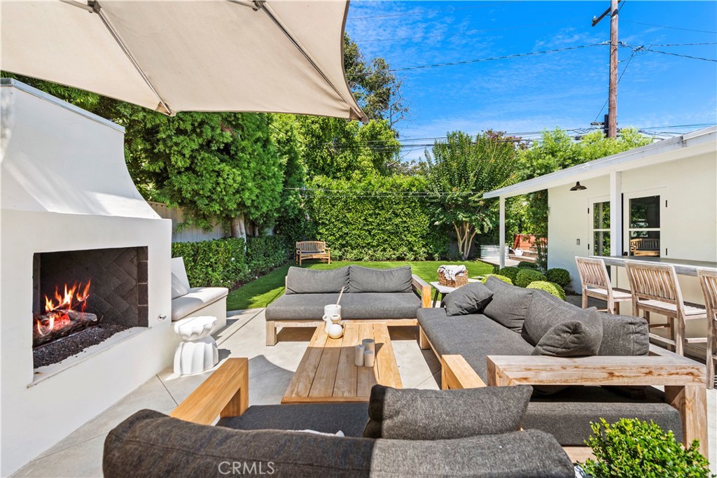 320 Broadway Costa Mesa, CA 92627 - Photo 24 of 43 a view of a patio with couches table and chairs under an umbrella