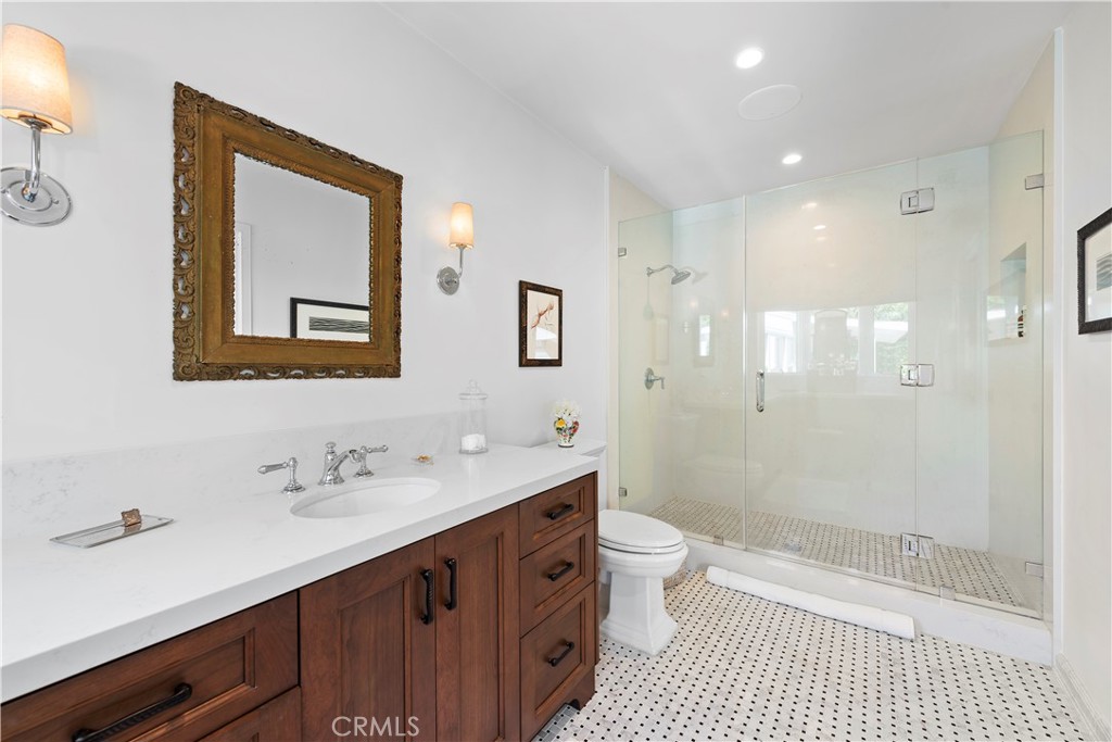 320 Broadway Costa Mesa, CA 92627 - Photo 39 of 43 a bathroom with a double vanity sink mirror double shower and a toilet