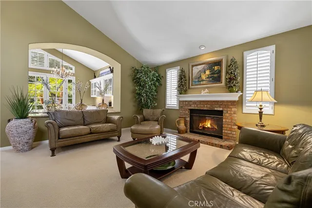 a large kitchen with kitchen island a large counter space a sink stainless steel appliances and cabinets