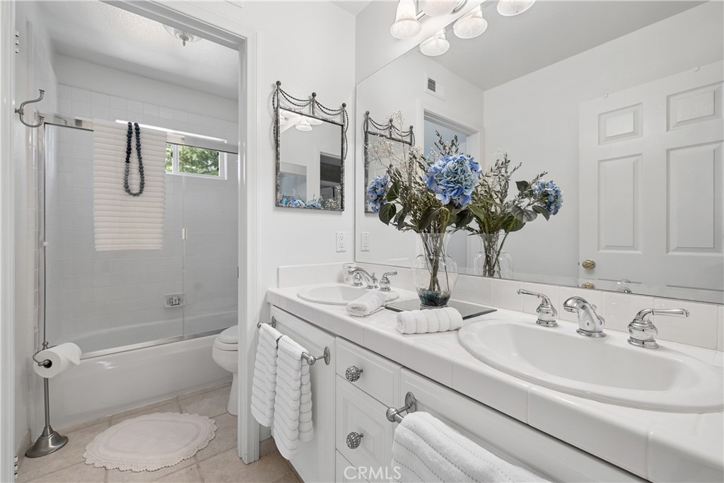 24587 Lola Lane Newhall, CA 91321 - Photo 25 of 44 a bathroom with a sink a toilet and shower
