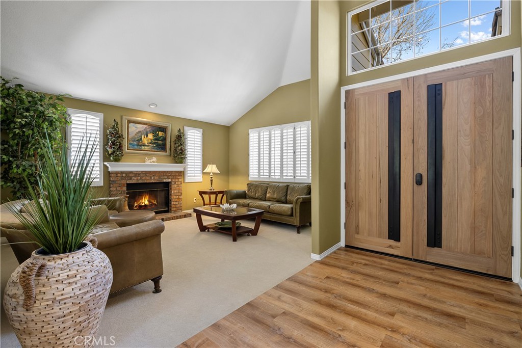 24587 Lola Lane Newhall, CA 91321 - Photo 6 of 44 a living room with furniture large window and a fireplace