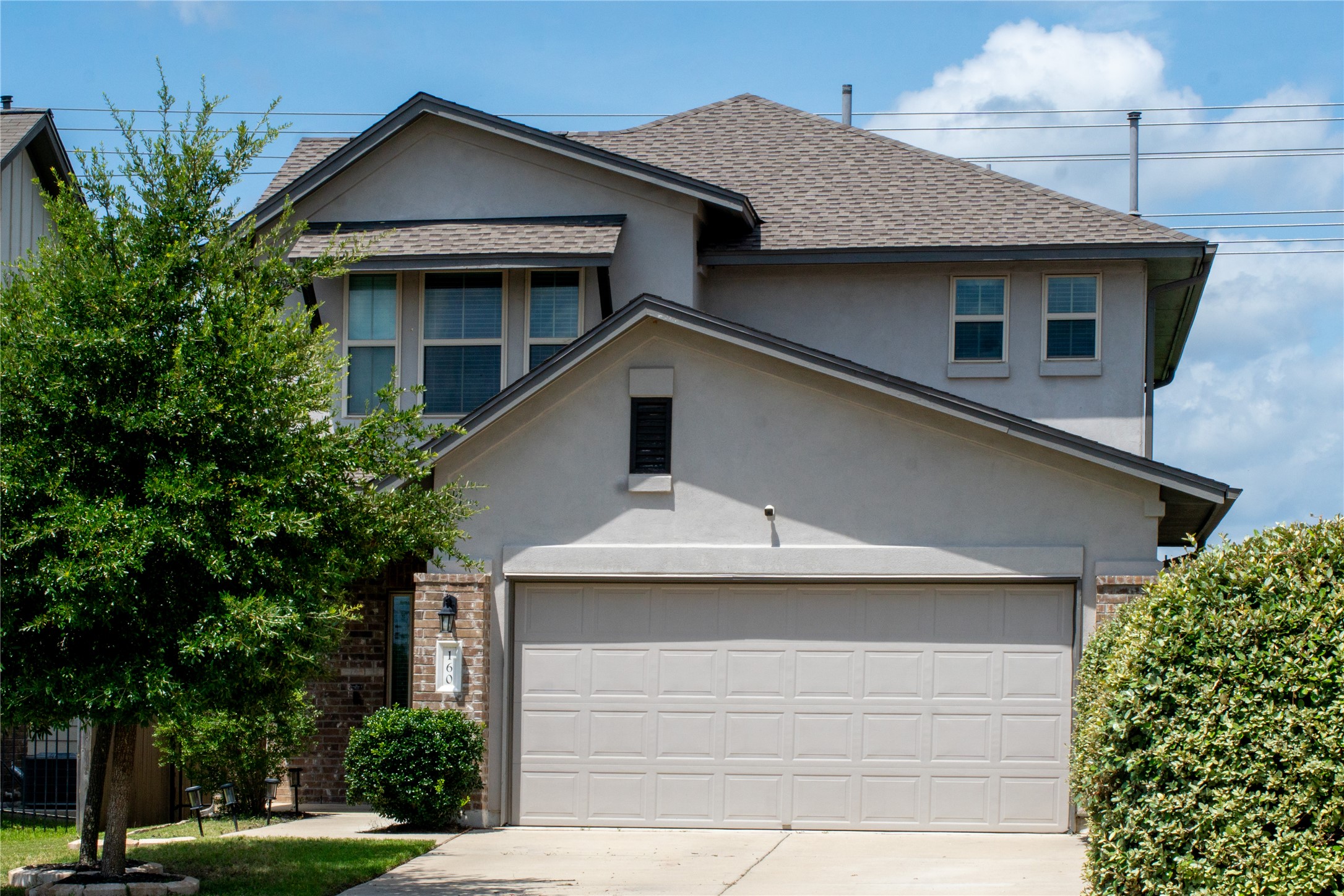 160 Shearwater Lane Leander, TX 78641 - Photo 1 of 1 View of front of home with a shingled roof, concrete driveway, stucco siding, and brick siding