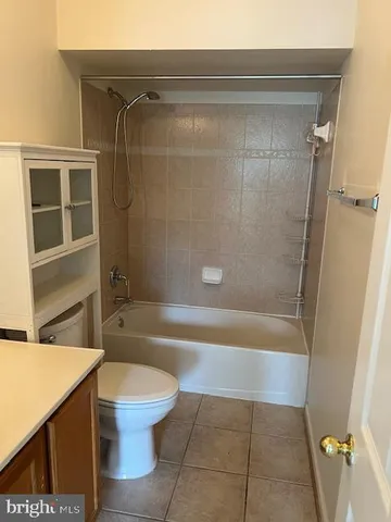 a bathroom with a shower a toilet and a sink